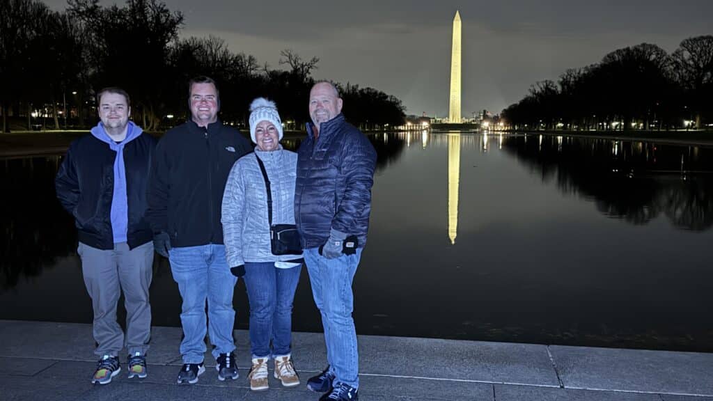 A family picture at the reflecting pool with Washington Monument in the background